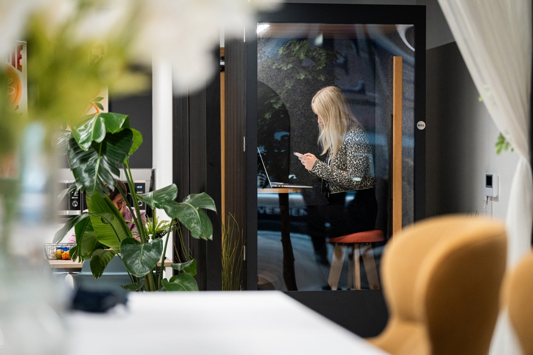 Office worker in an acoustic booth